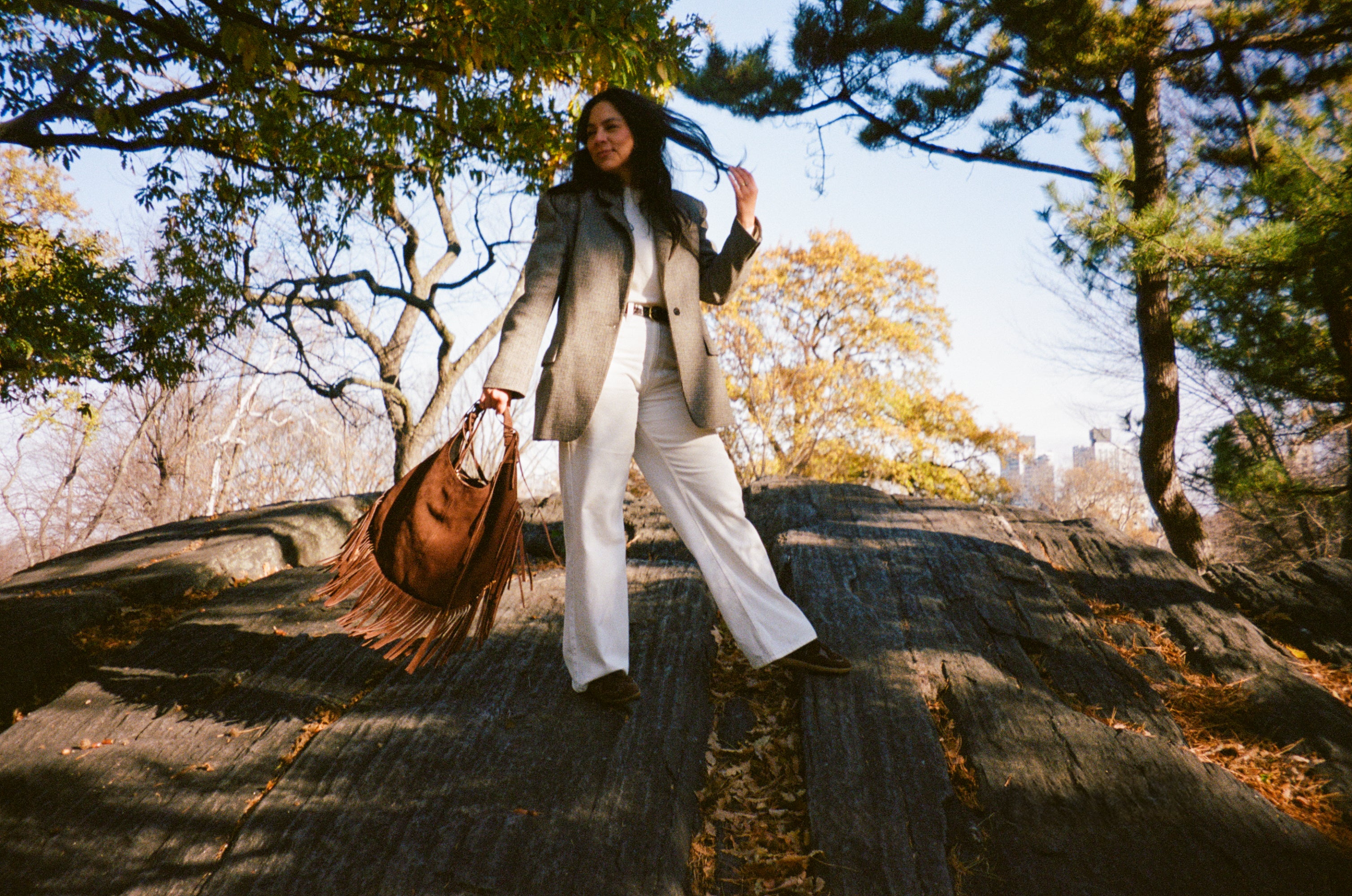 WOMAN HOLDING A BROWN FRINGES HANDBAG